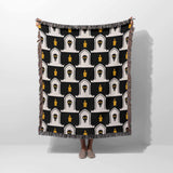 Black and white patterned throw blanket draped over a person on a white background