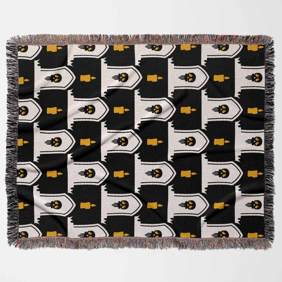 Patterned blanket with black, white, and yellow design on a white background