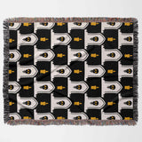 Patterned blanket with black, white, and yellow design on a white background