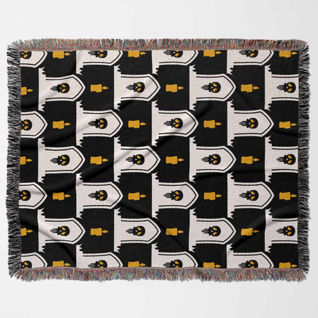Patterned blanket with black, white, and yellow design on a white background