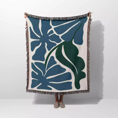 Henri Matisse blue flowers woven throw blanket with blue and green leaf pattern on a white background