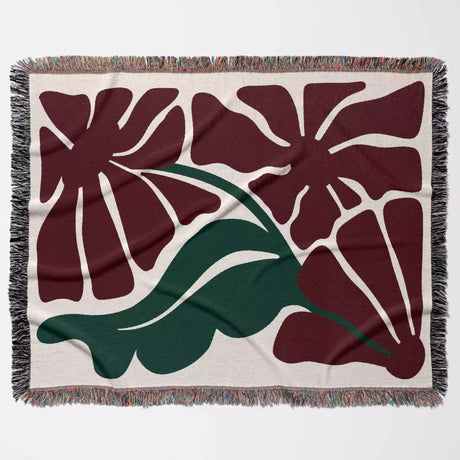 Floral patterned Henri Matisse red flowers woven throw blanket with red flowers and green leaves on a beige background