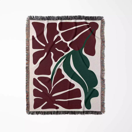 Floral patterned Henri Matisse red flowers woven throw blanket with red and green design on a beige background