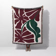 Floral patterned Henri Matisse red flowers woven throw blanket with red and green leaves on a white background