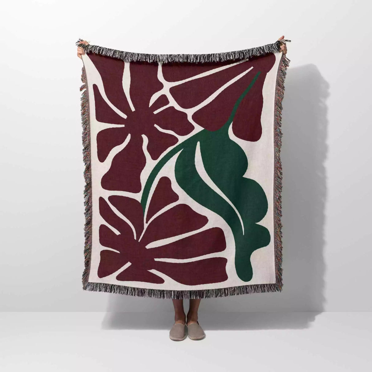 Floral patterned Henri Matisse red flowers woven throw blanket with red and green leaves on a white background