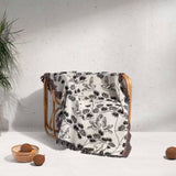 Wooden chair with a Japanese style woven blanket throw tapestry on a light background