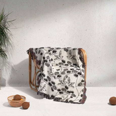 Wooden chair with a Japanese style woven blanket throw tapestry on a light background
