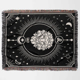 The flat horizontal view of the Leo Zodiac Blanket highlights the detailed design featuring the Leo lion emblem surrounded by celestial symbols. The multicolor fringe adds a vibrant border, enhancing the overall aesthetic.