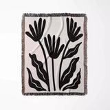 Matisse flowers black and white woven throw blanket with black floral pattern on a white background