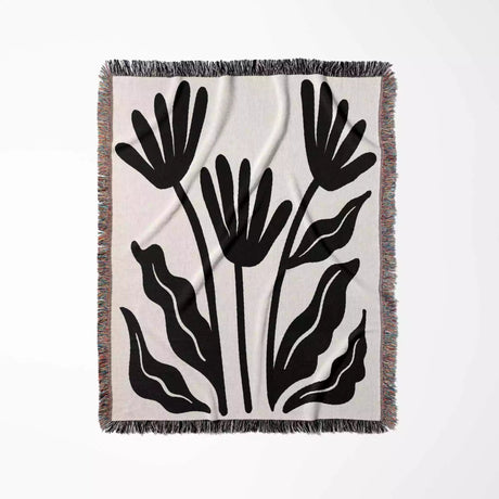 Matisse flowers black and white woven throw blanket with black floral pattern on a white background