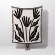 Matisse flowers black and white woven throw blanket with black leaf pattern on a white background
