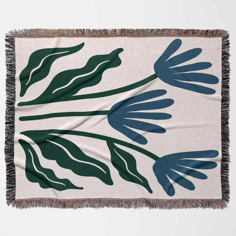 Matisse inspired blue flowers woven throw blanket with green and blue floral pattern on a beige background