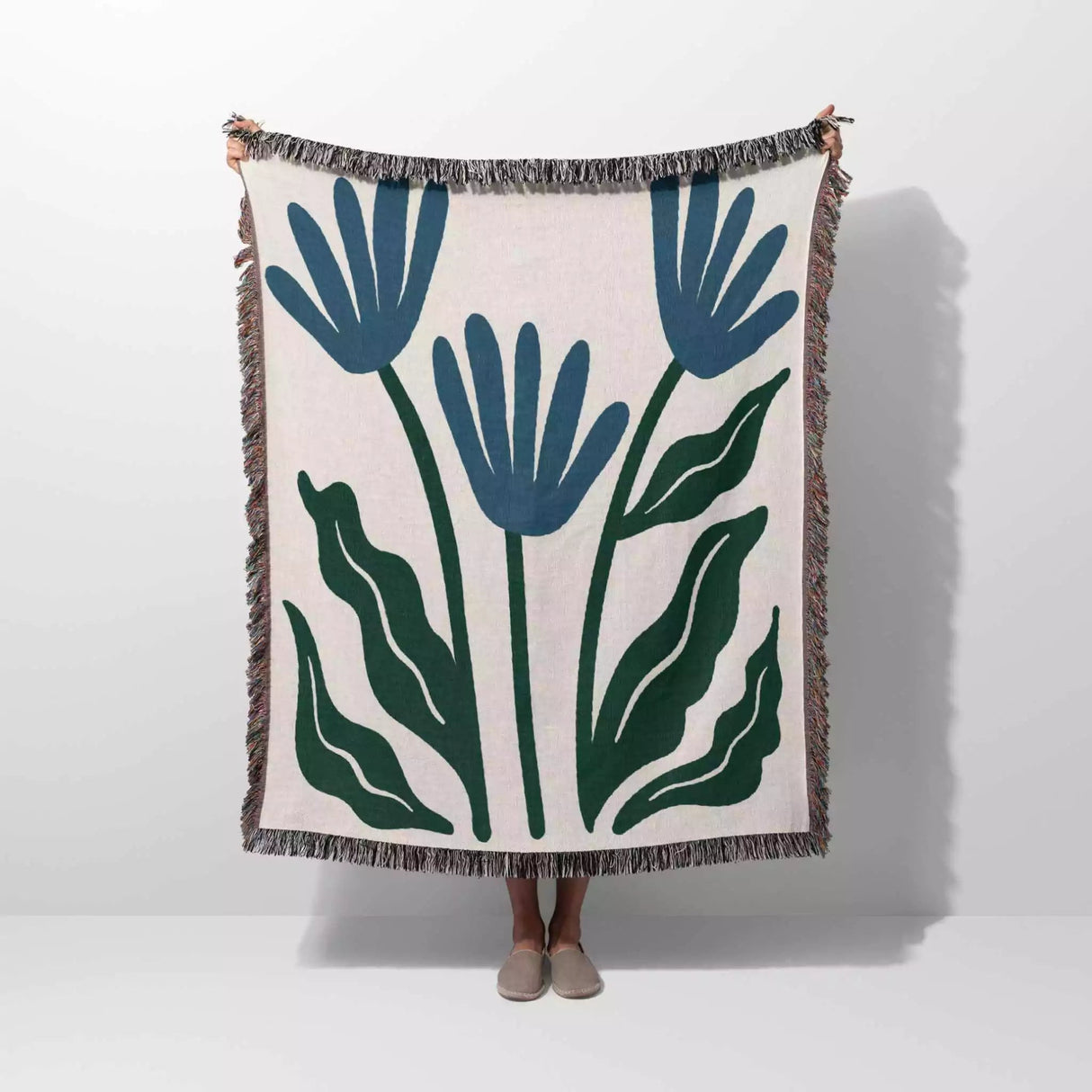 Matisse inspired blue flowers woven throw blanket with blue and green floral design on a white background