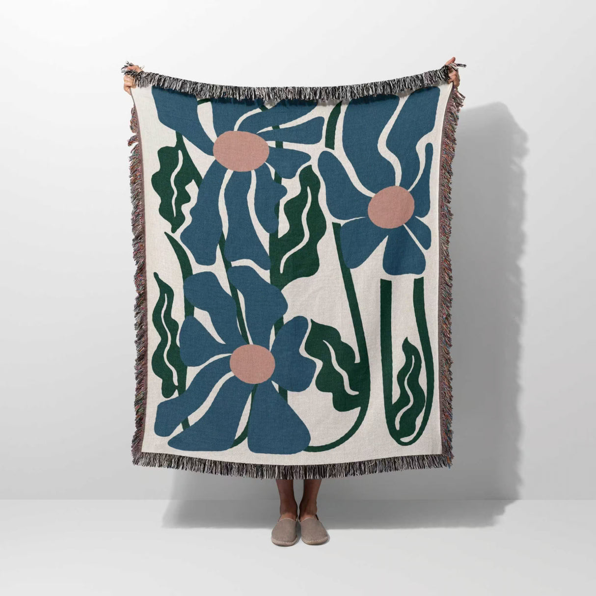 Floral patterned Matisse style blue flowers cotton woven throw blanket with blue flowers on a white background