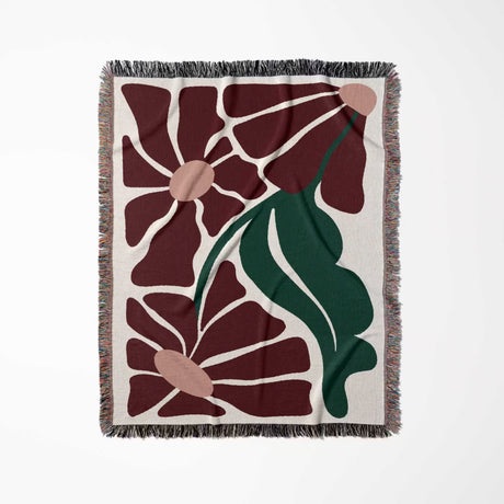 Floral patterned style botanical cotton woven throw blanket with red, green, and beige colors on a white background
