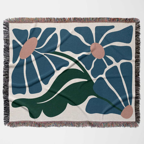 Matisse style floral cotton woven throw blanket for couch with blue flowers and green leaves on a beige background