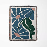 Matisse style floral cotton woven throw blanket for couch with blue, green, and off-white colors on a white background