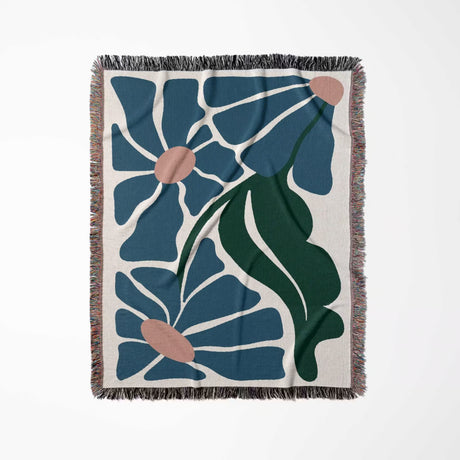 Matisse style floral cotton woven throw blanket for couch with blue, green, and off-white colors on a white background
