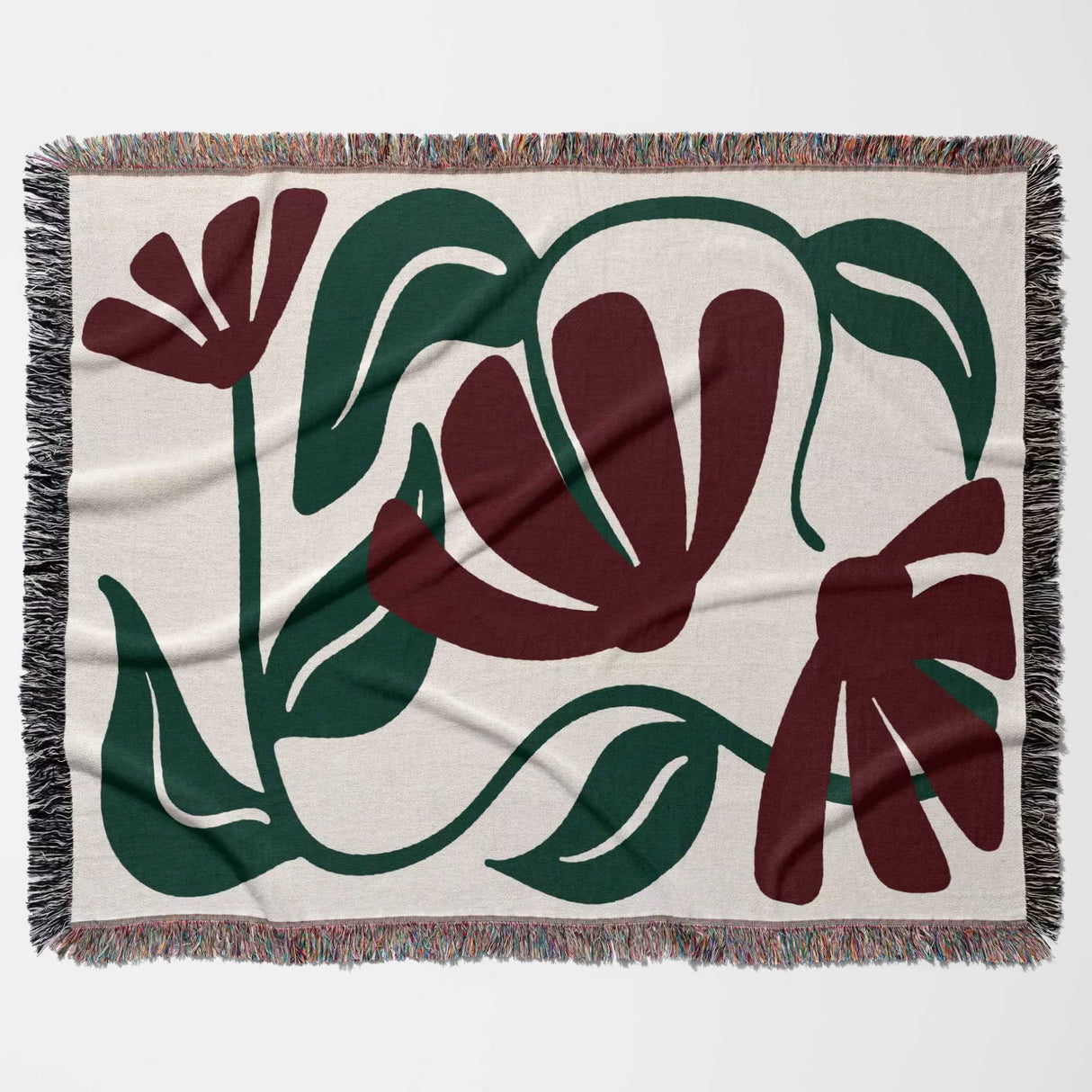 Floral patterned Matisse style red floral cotton woven throw blanket with green and red flowers on a beige background