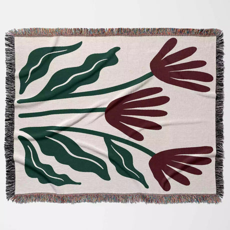 Floral patterned Matisse style red flowers woven throw blanket with green leaves and red flowers on a beige background