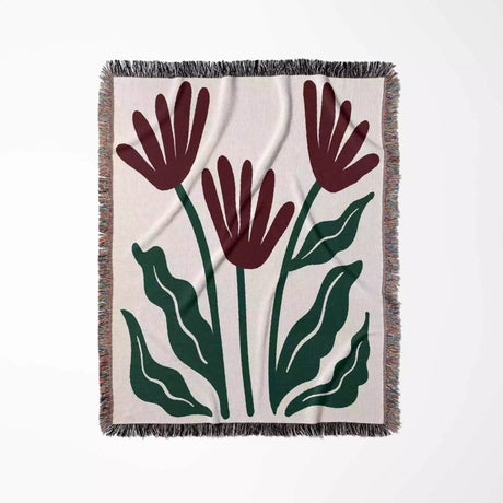 Floral patterned Matisse style red flowers woven throw blanket with red flowers and green leaves on a beige background