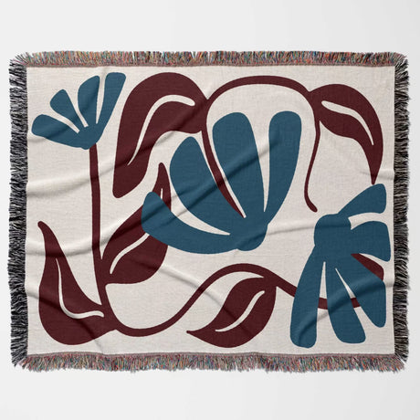 Decorative Matisse style red and blue cotton woven throw blanket with abstract blue and brown floral design on a beige background