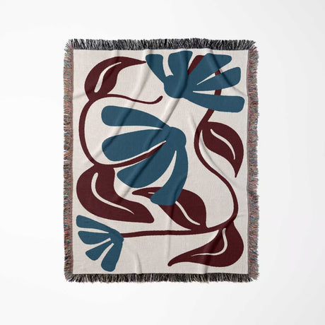Decorative Matisse style red and blue cotton woven throw blanket with blue and brown floral pattern on a white background