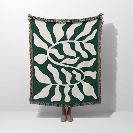 Matisse throw blanket green leaf abstract tapestry held by a person on a white background