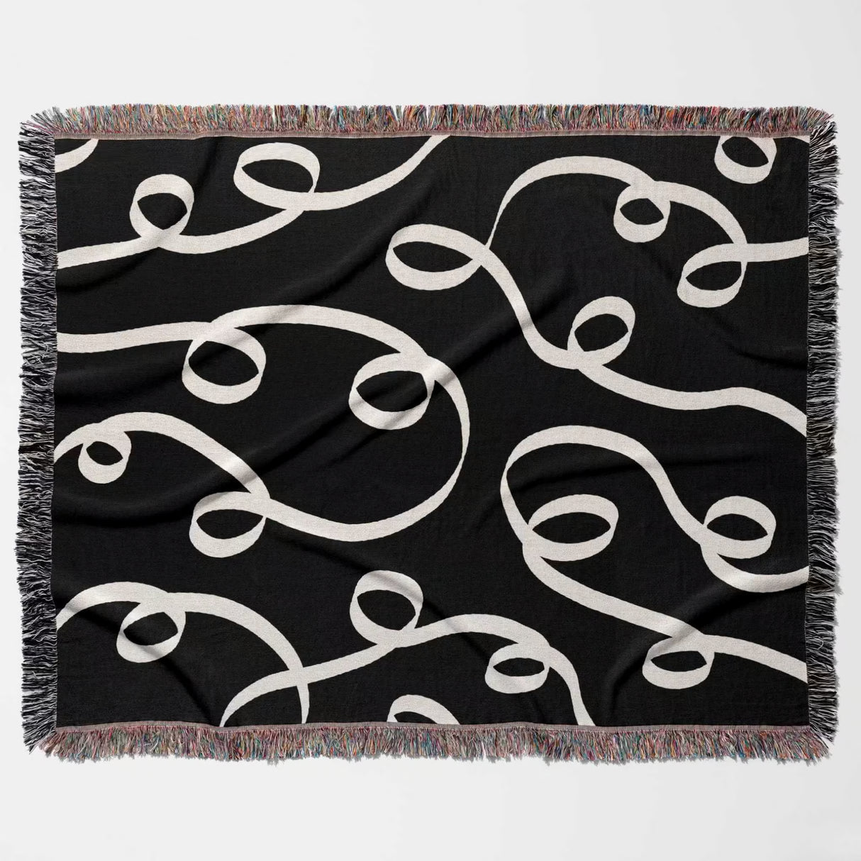 Black and white modern accent woven blanket throw tapestry flat lay on a white background.