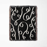 Black and white modern accent woven blanket throw tapestry full view on a white background.
