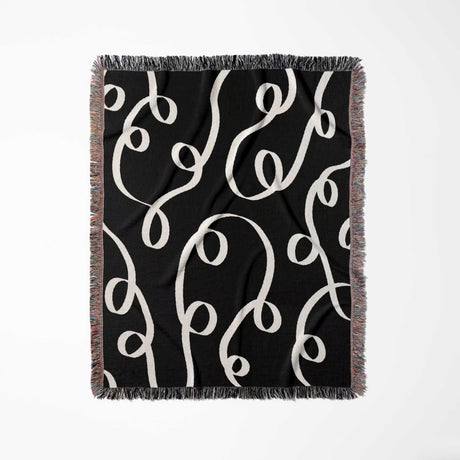 Black and white modern accent woven blanket throw tapestry full view on a white background.