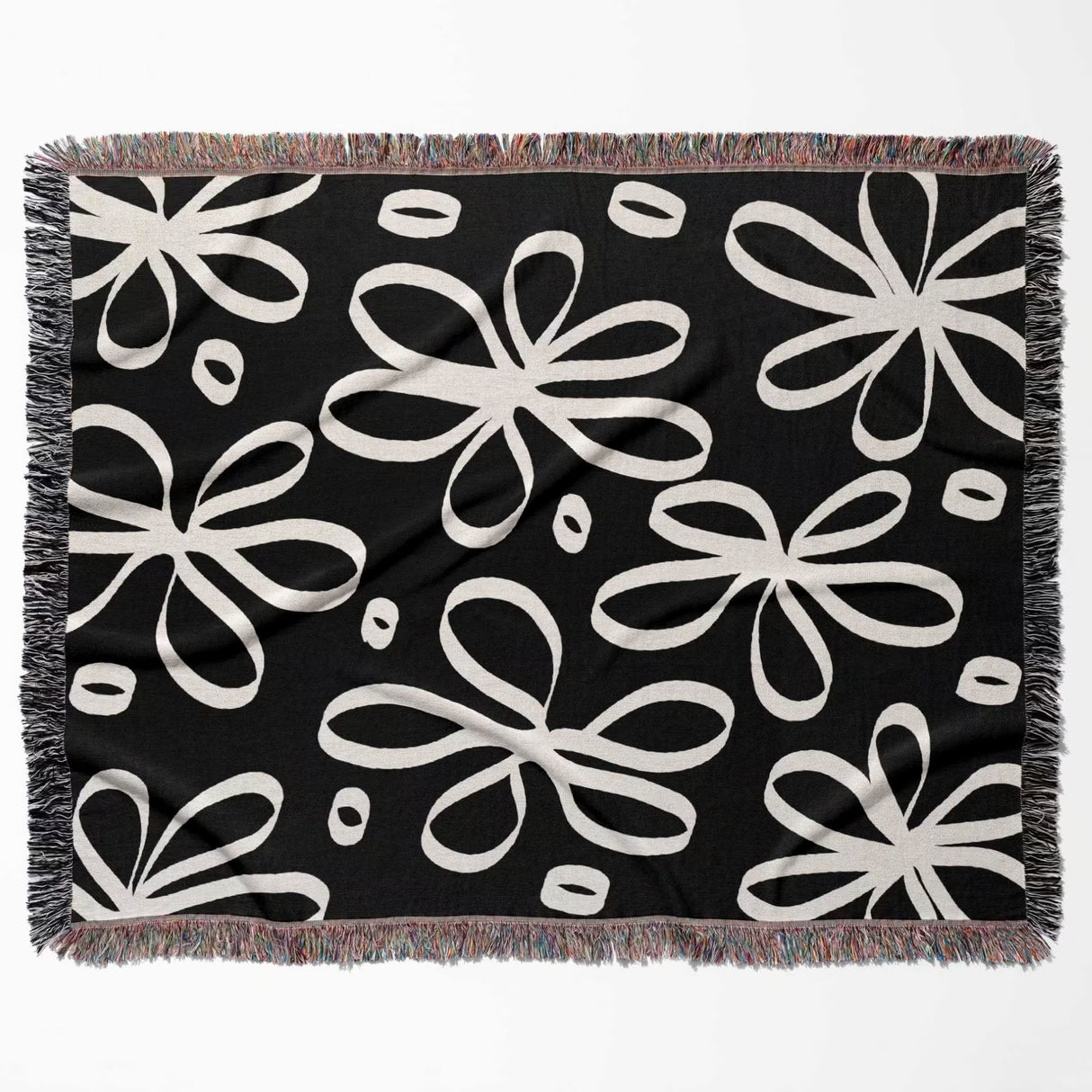 Black and white modern artsy flowers woven blanket throw flat lay on a white background.