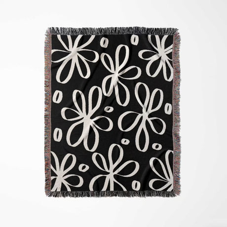 Black and white modern artsy flowers woven blanket throw full view on a white background.