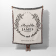 Mr and Mrs cotton wedding anniversary gift woven blanket with floral design and text held by a person on a white background