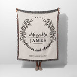 Mr and Mrs cotton wedding anniversary gift woven blanket with floral design and text held by a person on a white background