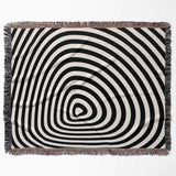 Black and white optical illusion hole woven blanket throw tapestry flat lay on a white background.