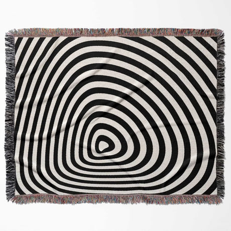 Black and white optical illusion hole woven blanket throw tapestry flat lay on a white background.