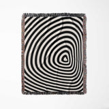 Black and white optical illusion hole woven blanket throw tapestry full view on a light gray background.
