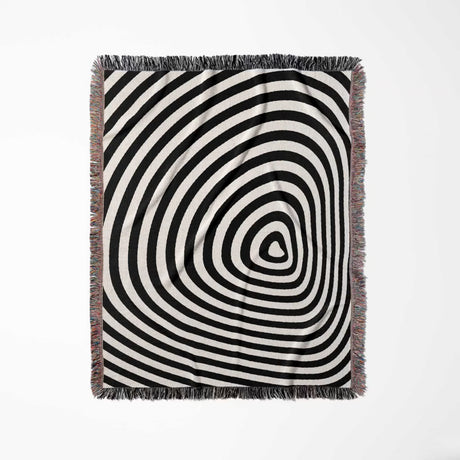 Black and white optical illusion hole woven blanket throw tapestry full view on a light gray background.