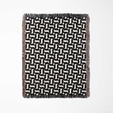 Black and white patterned geometric woven blanket throw tapestry with geometric design full view on a white background.