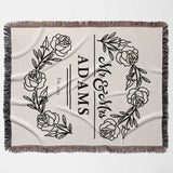 Personalized 2 year anniversary gift - Mr and Mrs woven throw blanket with floral designs and 'ADAMS' text flat lay on a white background