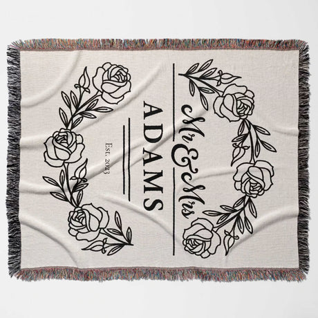 Personalized 2 year anniversary gift - Mr and Mrs woven throw blanket with floral designs and 'ADAMS' text flat lay on a white background
