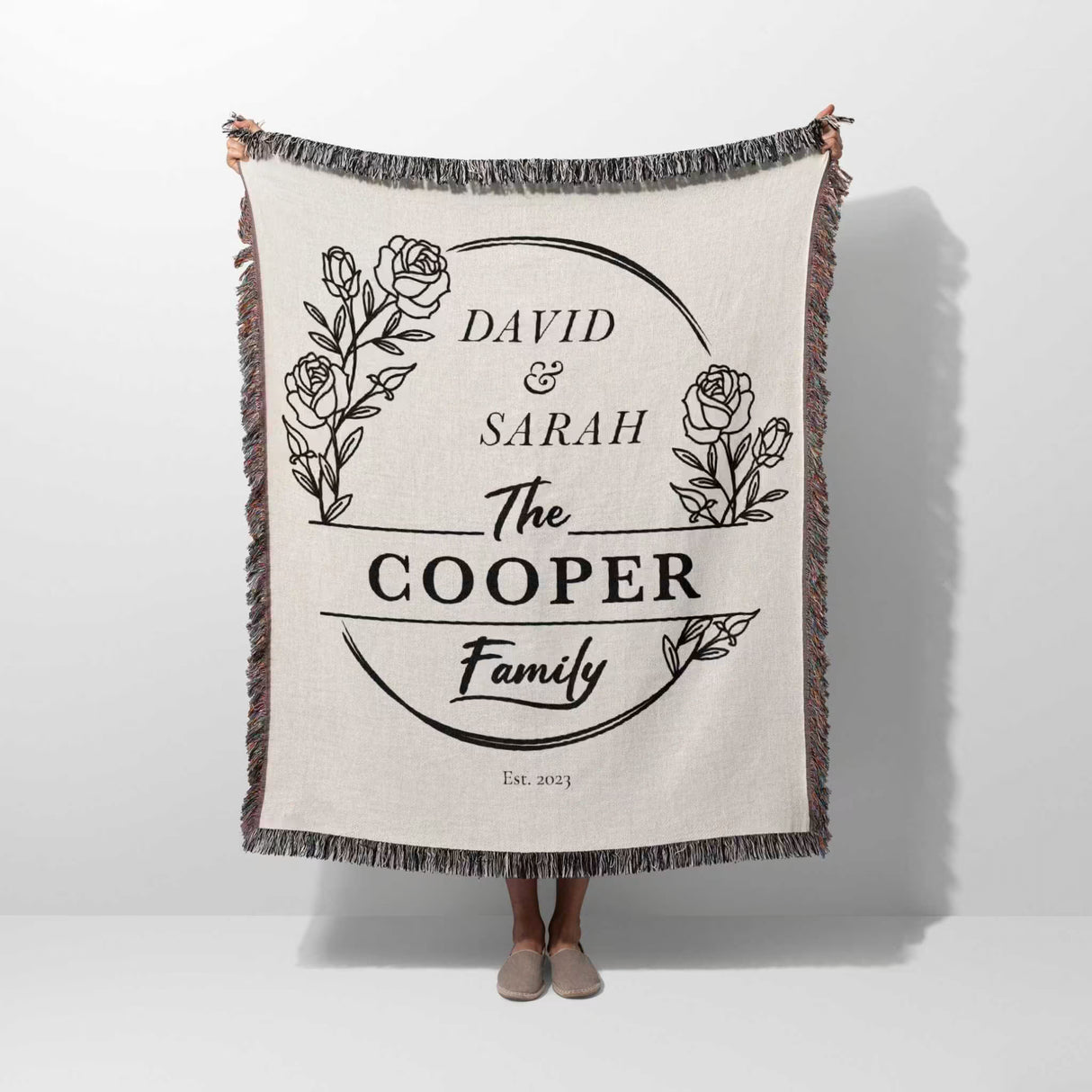 Personalized 2 year anniversary gift for wife woven throw blanket with 'David & Sarah The Cooper Family' text and floral design on a white background