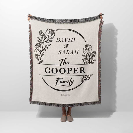 Personalized 2 year anniversary gift for wife woven throw blanket with 'David & Sarah The Cooper Family' text and floral design on a white background