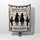 Personalized cowboy and cowgirl cotton anniversary gift woven throw blanket with cowboy design and text, held by a person on a white background