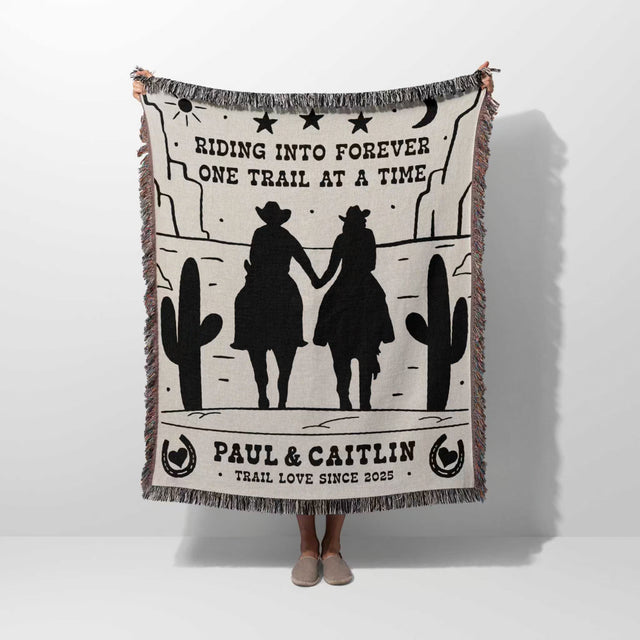 Personalized cowboy and cowgirl cotton anniversary gift woven throw blanket with cowboy design and text, held by a person on a white background