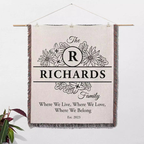Personalized family name blanket - new home unique housewarming gift with 'The Richards Family' design on a white wall.