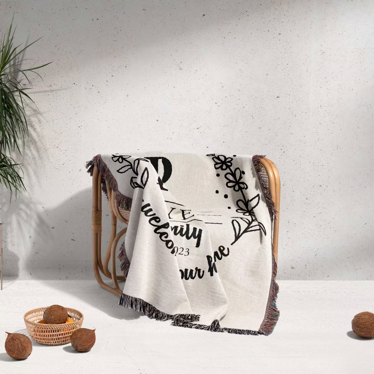Personalized family name woven blanket rustic home décor gift with text and patterns draped over a chair on a light background