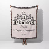 Personalized family name and address blanket with 'Harrison Family' design held by a person on a white background