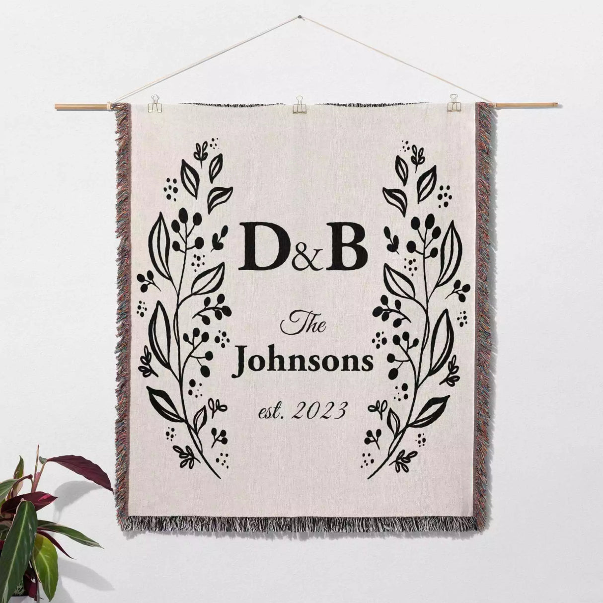 Personalized gift for couple unique cotton anniversary gift woven blanket hanging on a wall on a white background.